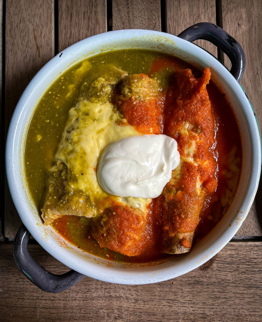 Quail enchiladas smothered in red chili sauce and cheese