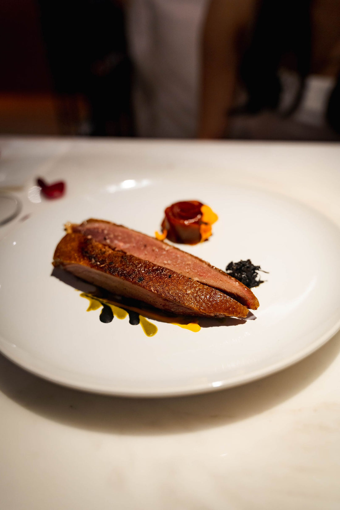 Pan-seared quail breast with fig sauce, fine dining plating