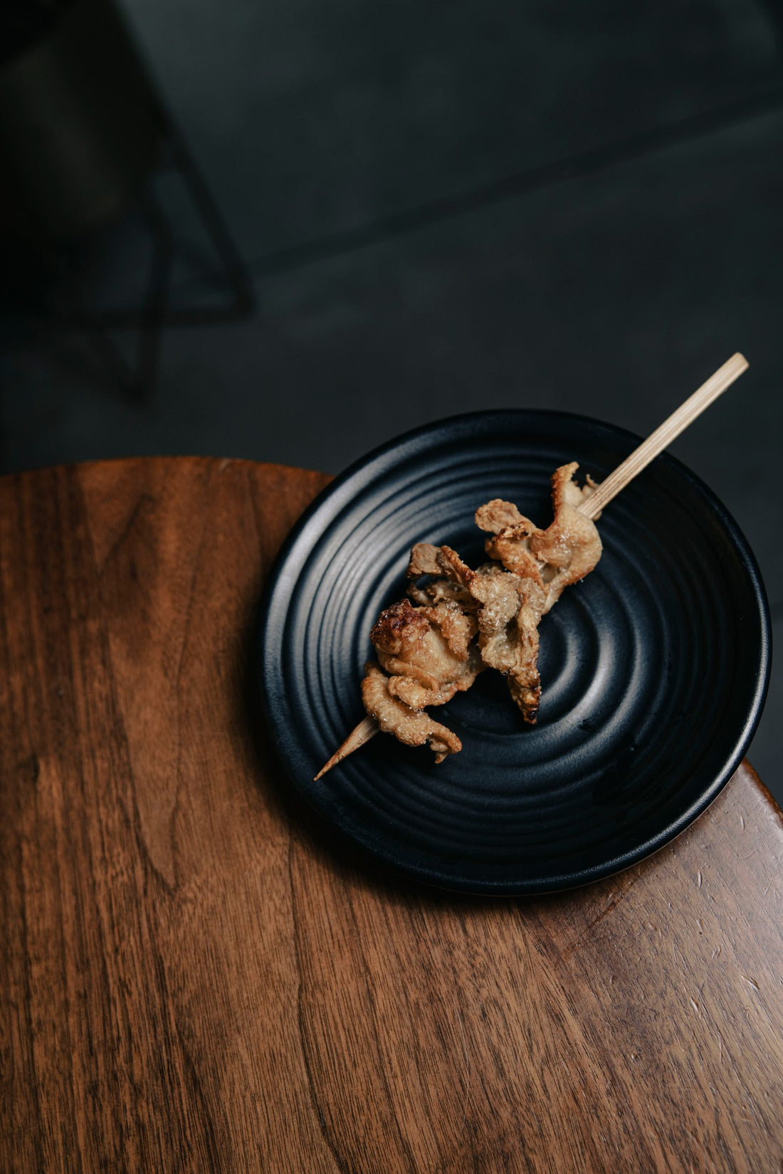 Crispy buttermilk fried quail on a dark plate