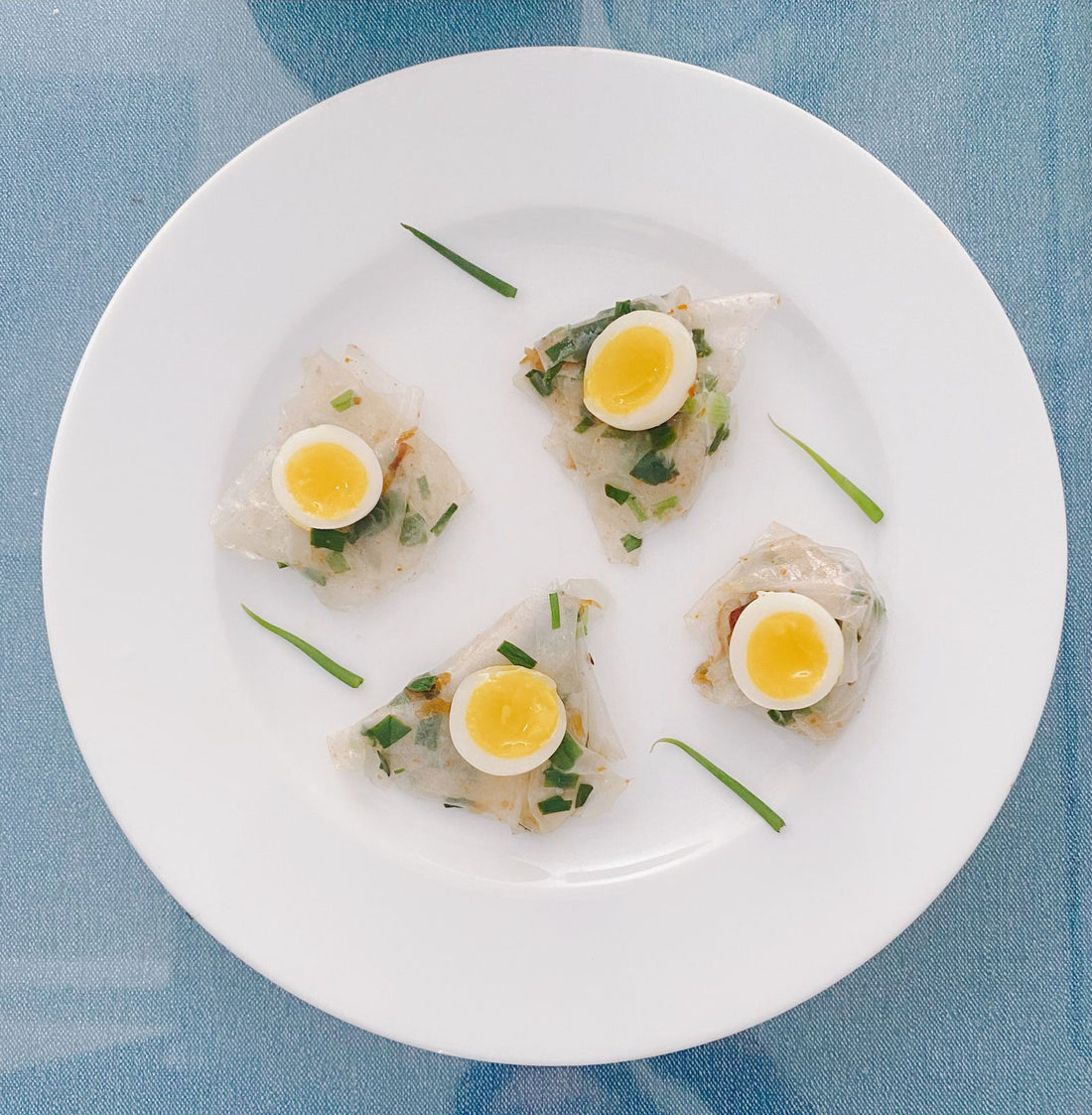 Deviled quail egg bites garnished with herbs