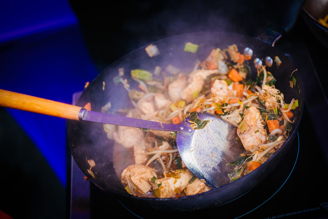 Quail stir fry with vegetables cooking in a wok