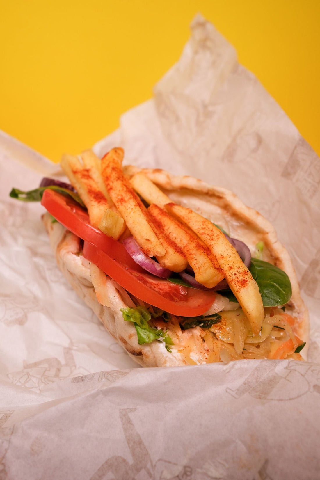Grilled quail pita wrap with vegetables and tzatziki